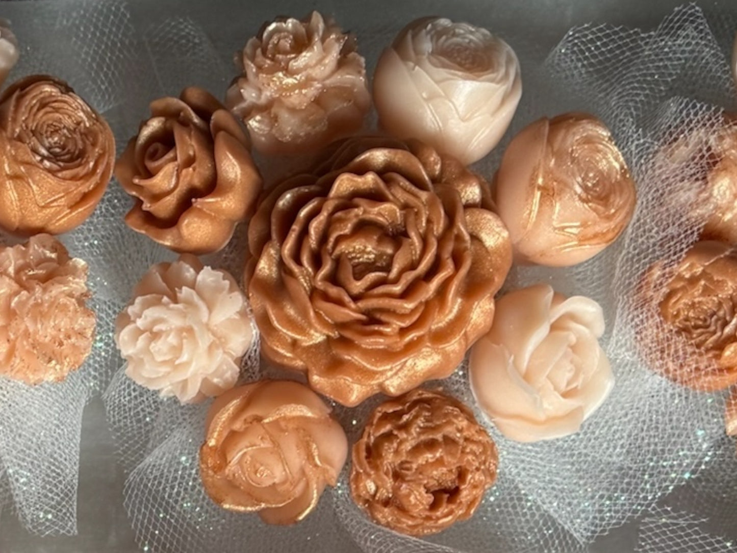 Decorative flowers in bronze and gold on a textured surface